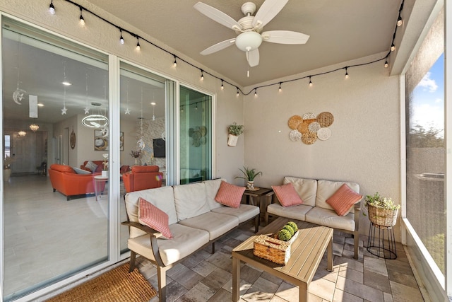 sunroom with track lighting and a ceiling fan