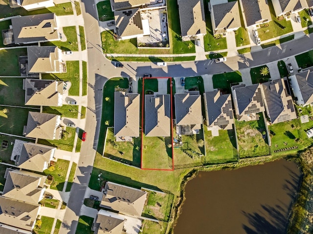 bird's eye view featuring a residential view and a water view