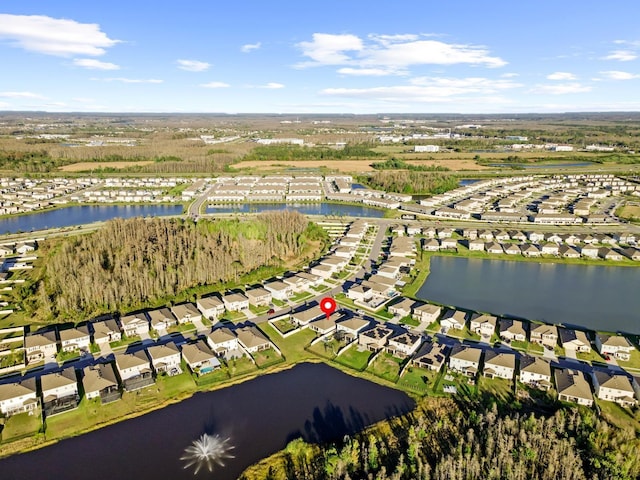 drone / aerial view featuring a water view and a residential view