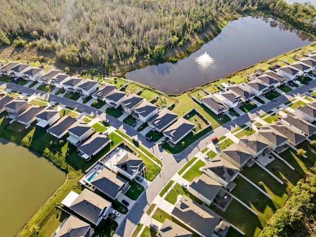 drone / aerial view with a residential view and a water view