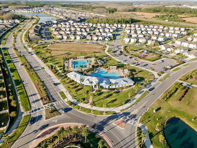 drone / aerial view with a residential view and a water view