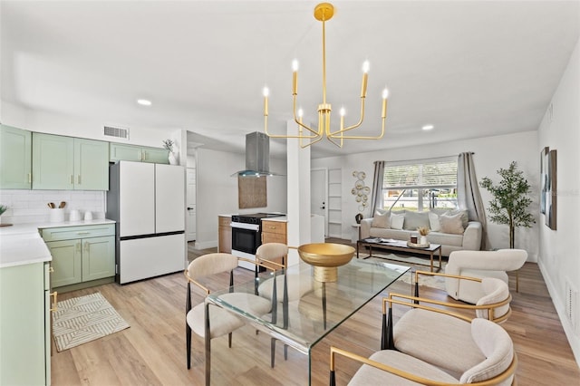 dining area featuring visible vents, baseboards, a chandelier, light wood-style flooring, and recessed lighting