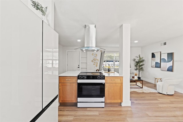 kitchen featuring visible vents, light wood-type flooring, electric stove, island exhaust hood, and light countertops