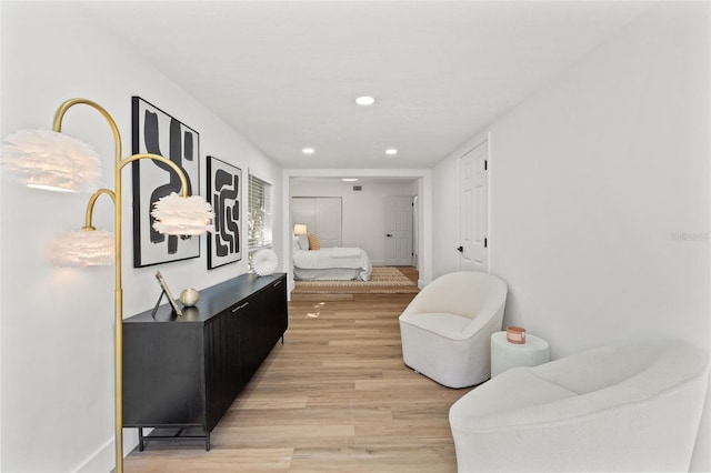 hall featuring recessed lighting, light wood-style floors, and baseboards