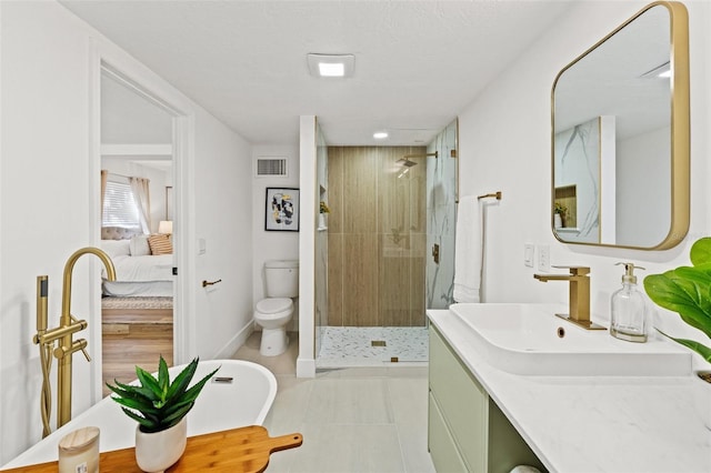 ensuite bathroom featuring visible vents, toilet, a stall shower, ensuite bath, and vanity