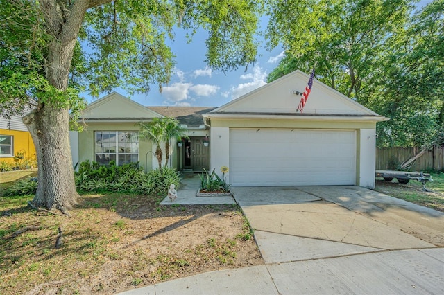 ranch-style house featuring stucco siding, an attached garage, driveway, and fence