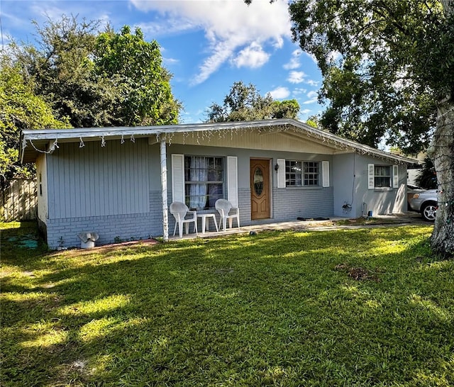 view of front of home featuring a front yard and brick siding