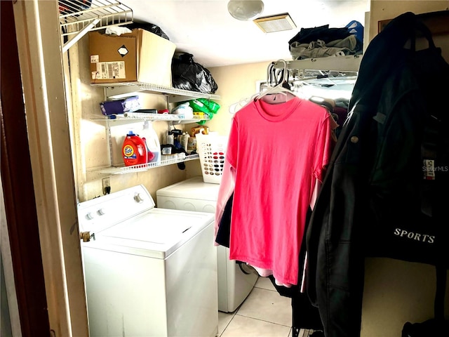 laundry room with laundry area, tile patterned floors, and washing machine and clothes dryer