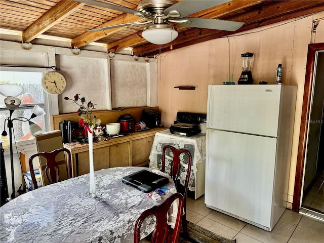 kitchen with tile patterned floors, beamed ceiling, wooden ceiling, and freestanding refrigerator