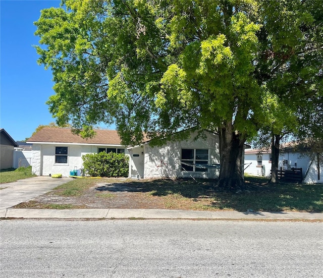 view of front of property with fence and stucco siding