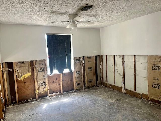 spare room featuring visible vents, a textured ceiling, and ceiling fan