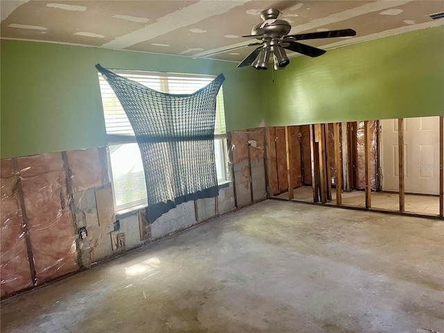 interior space featuring visible vents, concrete floors, and a ceiling fan