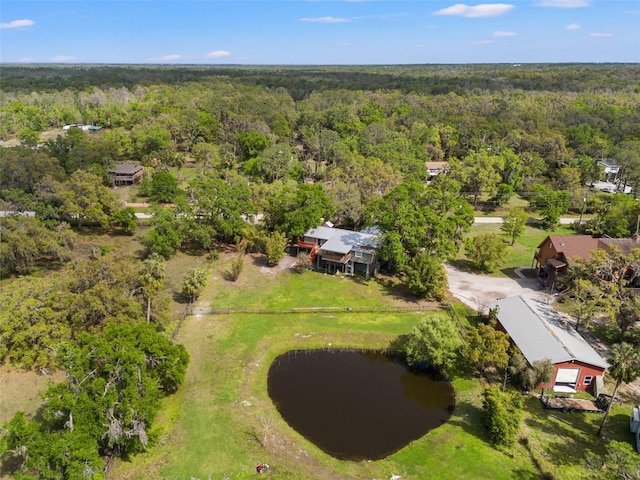 aerial view with a wooded view and a water view