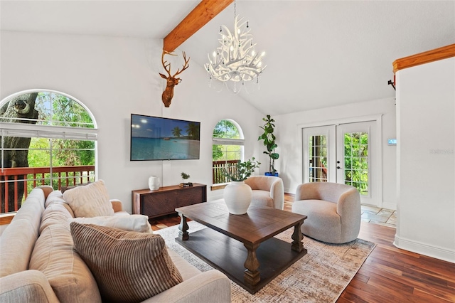 living area with beamed ceiling, high vaulted ceiling, wood finished floors, french doors, and a chandelier