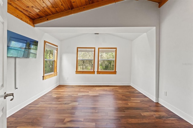 empty room featuring baseboards, lofted ceiling, wood finished floors, and wooden ceiling