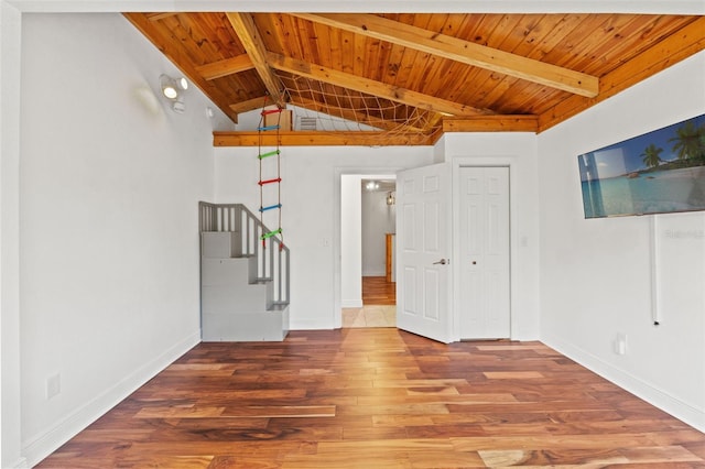 spare room featuring baseboards, wood finished floors, and wooden ceiling