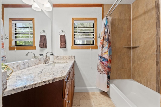 full bath featuring baseboards, plenty of natural light, shower / tub combo with curtain, and vanity