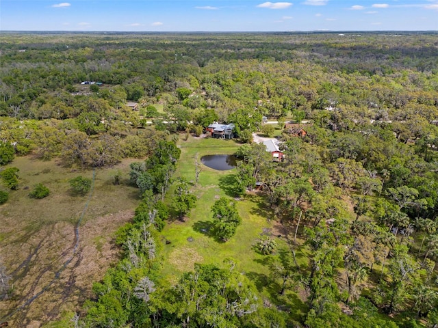 birds eye view of property with a view of trees