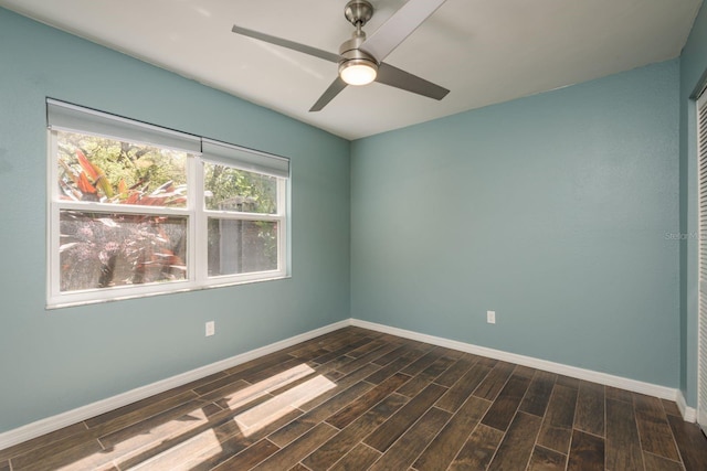 empty room with wood finish floors, baseboards, and a ceiling fan