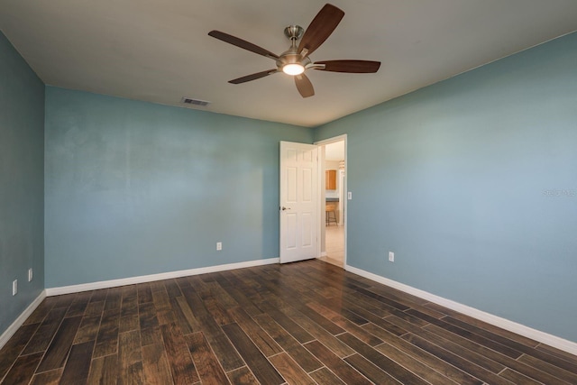 unfurnished room featuring visible vents, baseboards, a ceiling fan, and wood finished floors