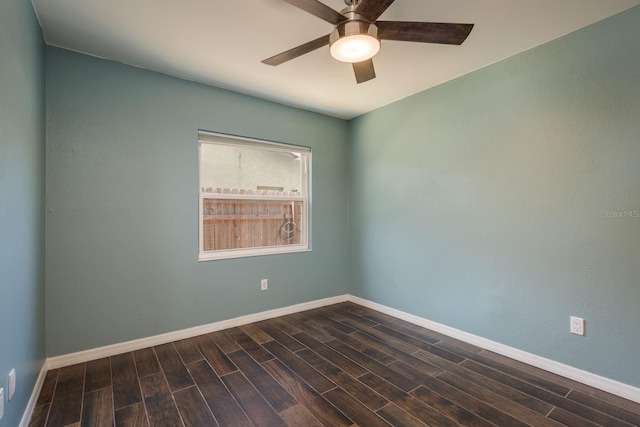 unfurnished room featuring dark wood-style floors, baseboards, and ceiling fan