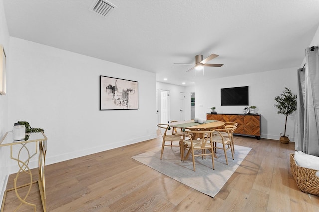 dining room featuring visible vents, light wood-style flooring, a ceiling fan, recessed lighting, and baseboards