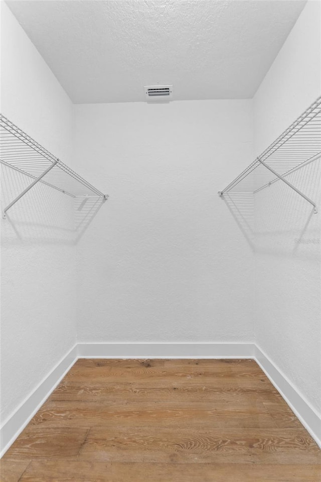 walk in closet featuring visible vents and light wood finished floors