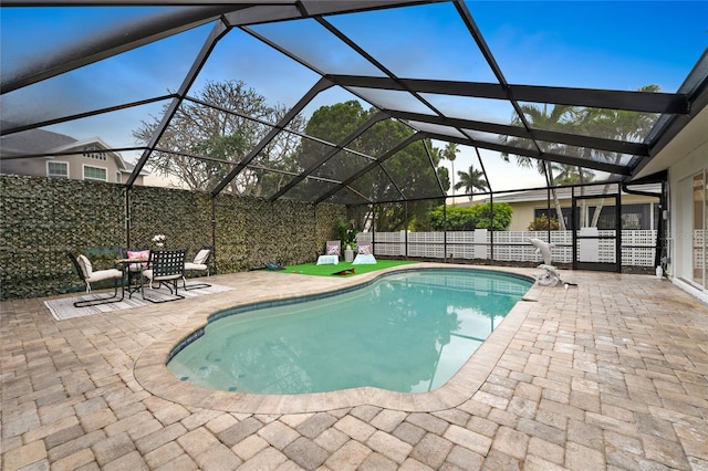 view of pool with a patio area, a fenced in pool, glass enclosure, and fence