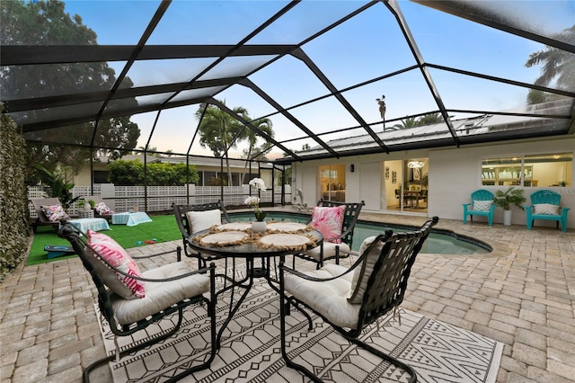 view of patio / terrace featuring glass enclosure and a fenced in pool