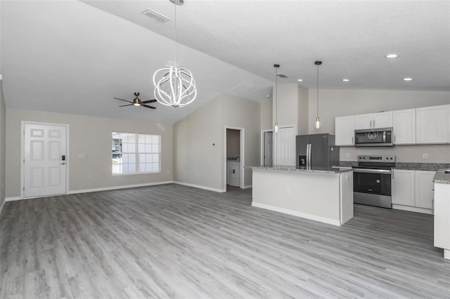 kitchen featuring a center island, light wood-style flooring, pendant lighting, and stainless steel appliances