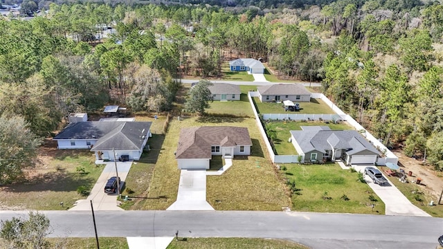 bird's eye view featuring a forest view and a residential view