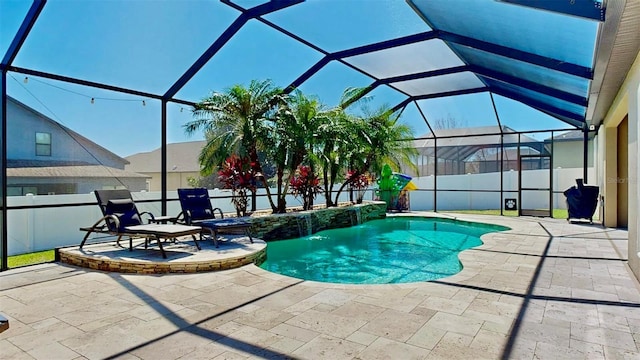 view of swimming pool featuring a lanai, a fenced in pool, a fenced backyard, and a patio area