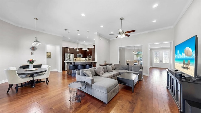 living room with baseboards, ornamental molding, recessed lighting, hardwood / wood-style flooring, and a ceiling fan