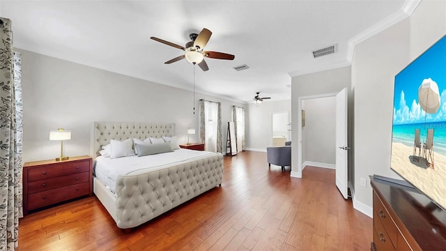 bedroom featuring ceiling fan, wood finished floors, visible vents, and baseboards