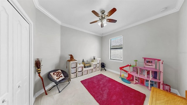 game room with crown molding, baseboards, carpet floors, and ceiling fan