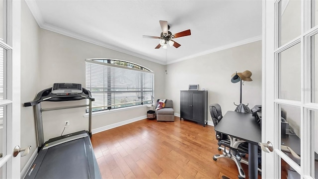 office with crown molding, light wood-style floors, baseboards, and ceiling fan