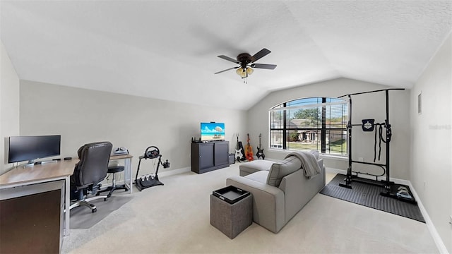 carpeted office space with a textured ceiling, lofted ceiling, baseboards, and ceiling fan