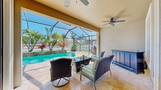 view of patio / terrace with a lanai, a fenced in pool, and ceiling fan