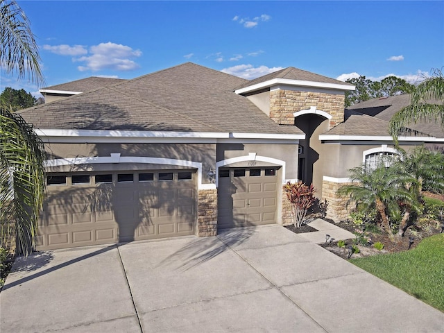 view of front of property featuring stucco siding, stone siding, concrete driveway, a shingled roof, and a garage