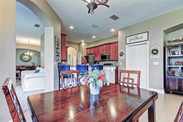 dining space featuring recessed lighting, light tile patterned floors, visible vents, and arched walkways