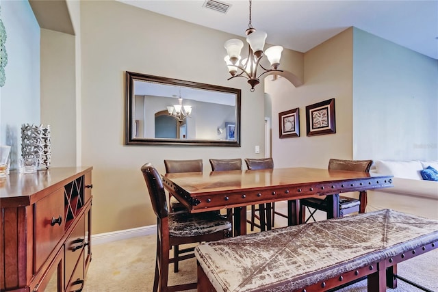 dining space featuring visible vents, light colored carpet, baseboards, and an inviting chandelier