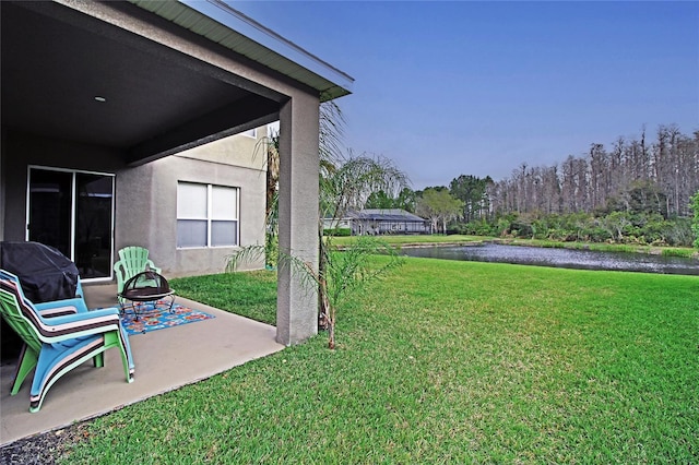 view of yard with a patio and a water view