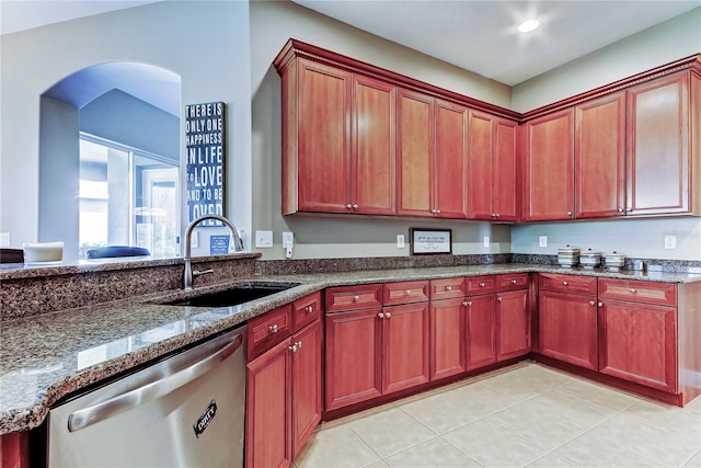 kitchen featuring a sink, dark brown cabinets, dark stone counters, and stainless steel dishwasher