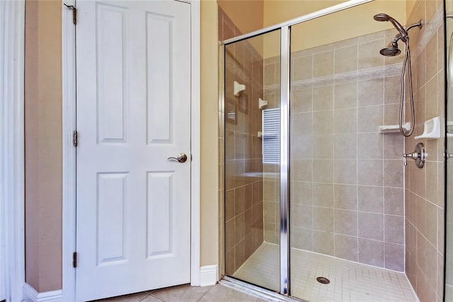 bathroom with tile patterned flooring and a stall shower