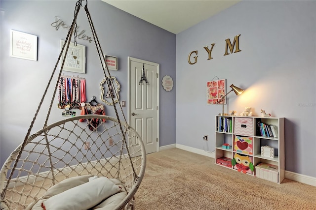 recreation room featuring baseboards and carpet floors