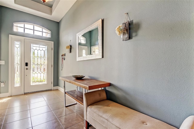 tiled foyer entrance with baseboards