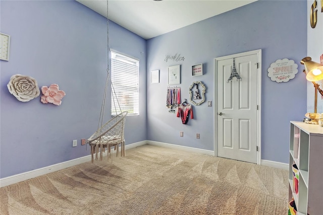 rec room with baseboards and carpet floors