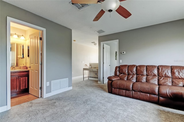 living room with visible vents, light colored carpet, and ceiling fan