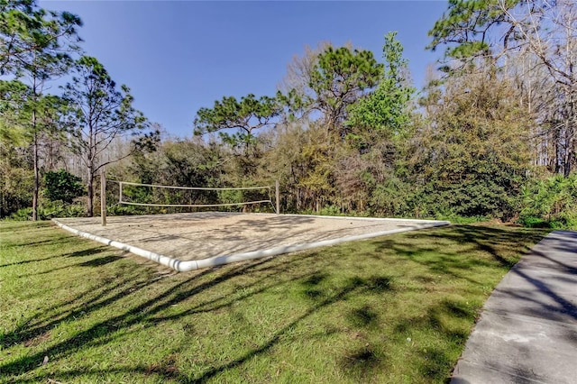 surrounding community with a lawn and volleyball court