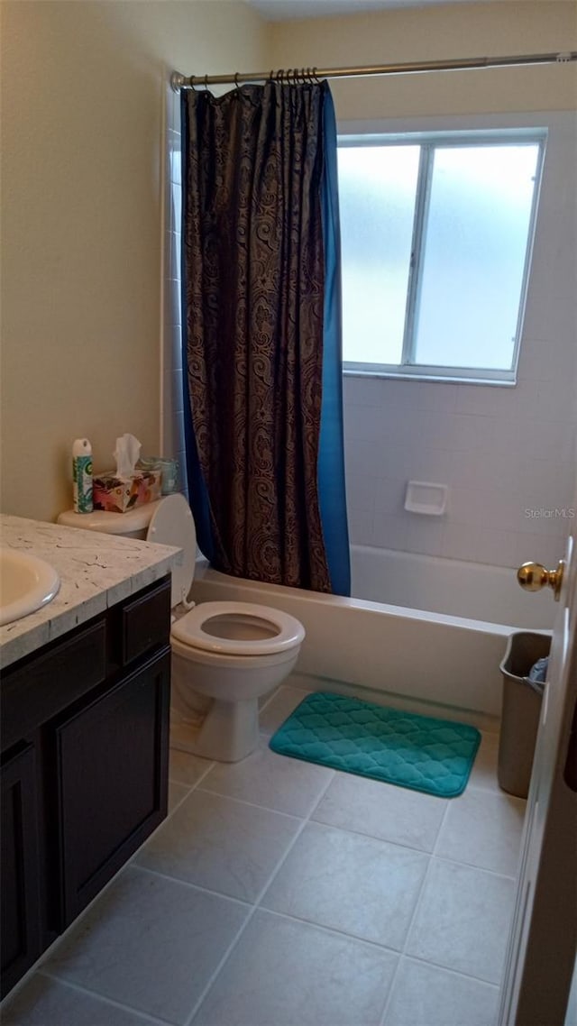 full bathroom with tile patterned floors, shower / bath combo with shower curtain, toilet, and vanity